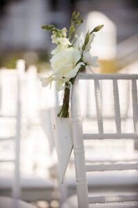 confetti cones and white rose wedding chair posies tied to white Tiffany chairs for the wedding ceremony